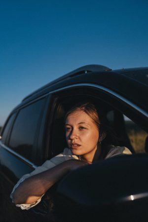 Woman looking out window waiting